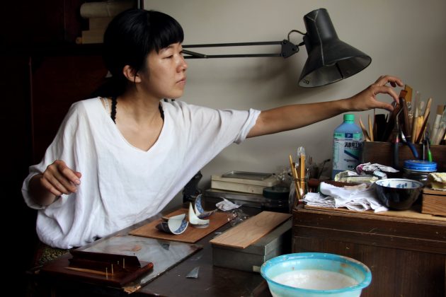 Mio Heki working at her desk